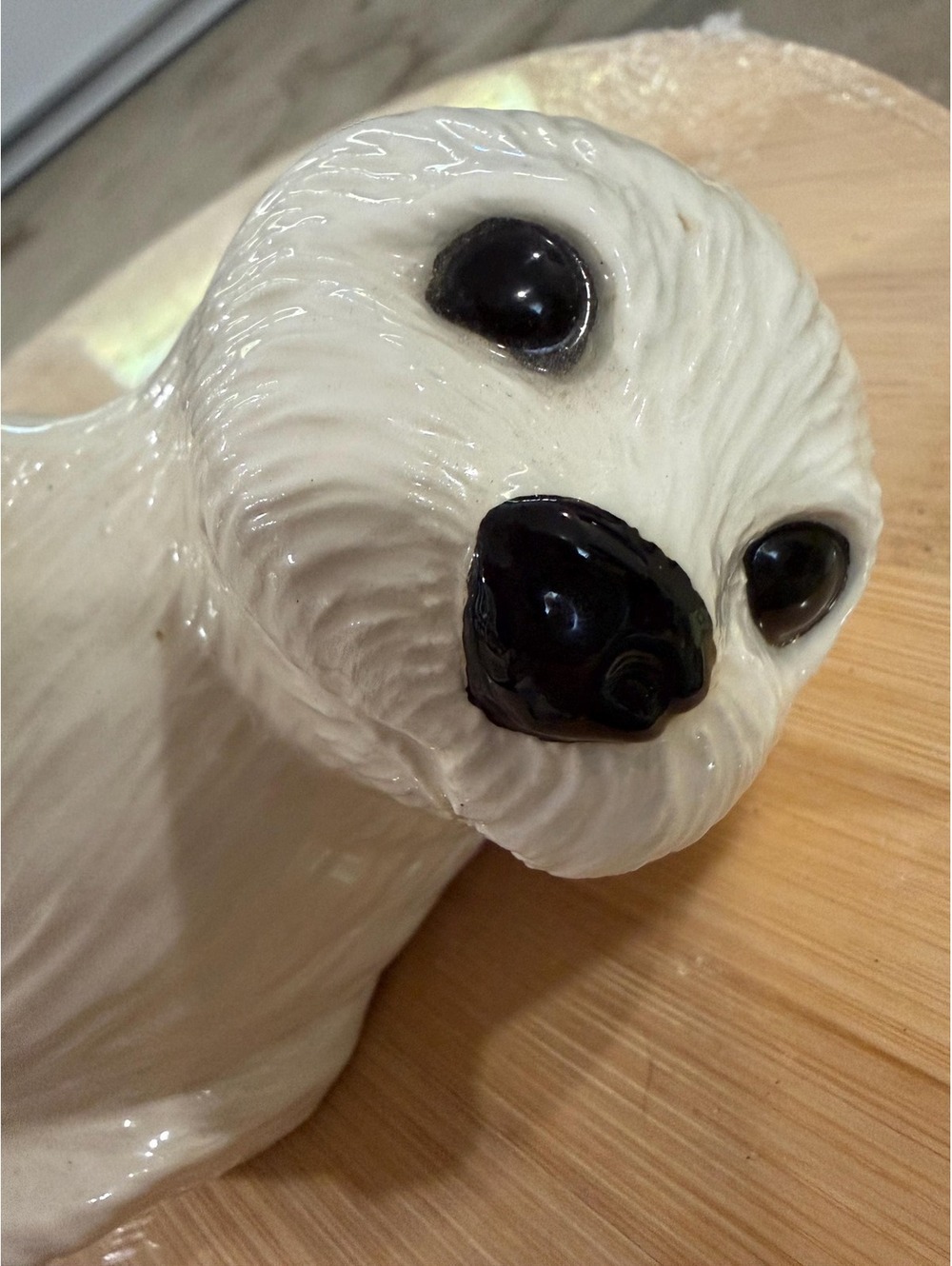 A 1987 porcelain Snow Pup seal figurine by Roslyn S. Carren for Franklin Mint.